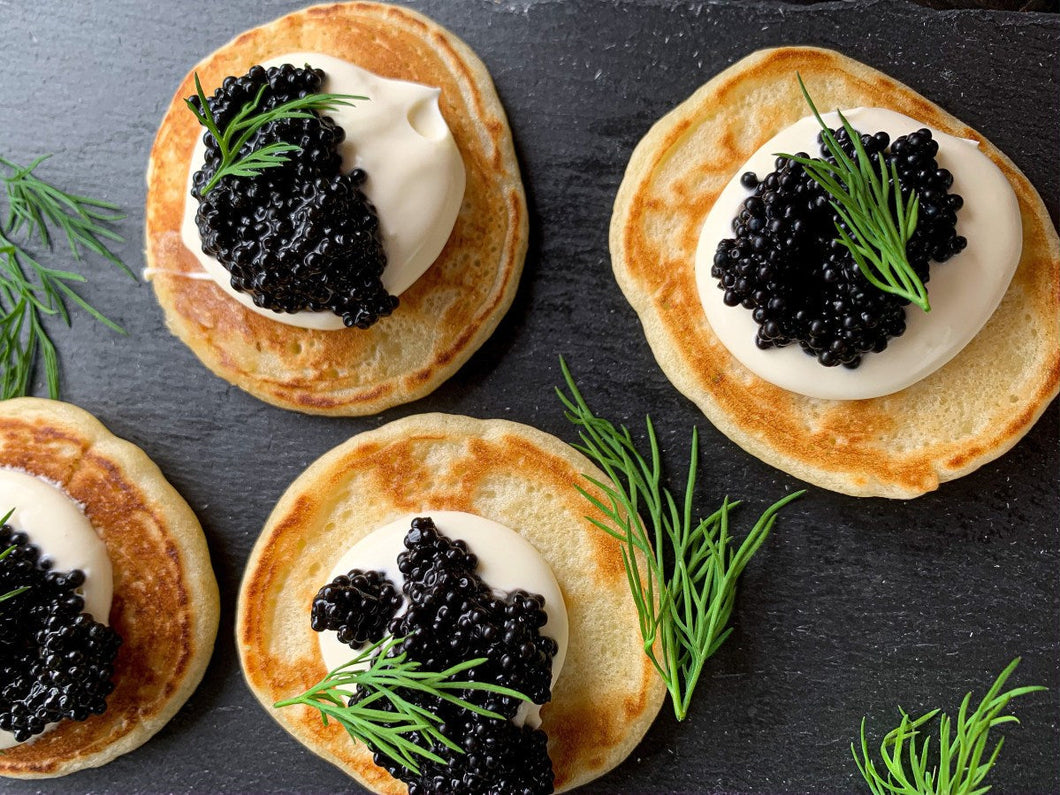 Caviar Board • Art of Eating Brioche, Blinis, Lemon, Chopped Onion and House Crème Fraiche – American Sturgeon or Imperial Osetra