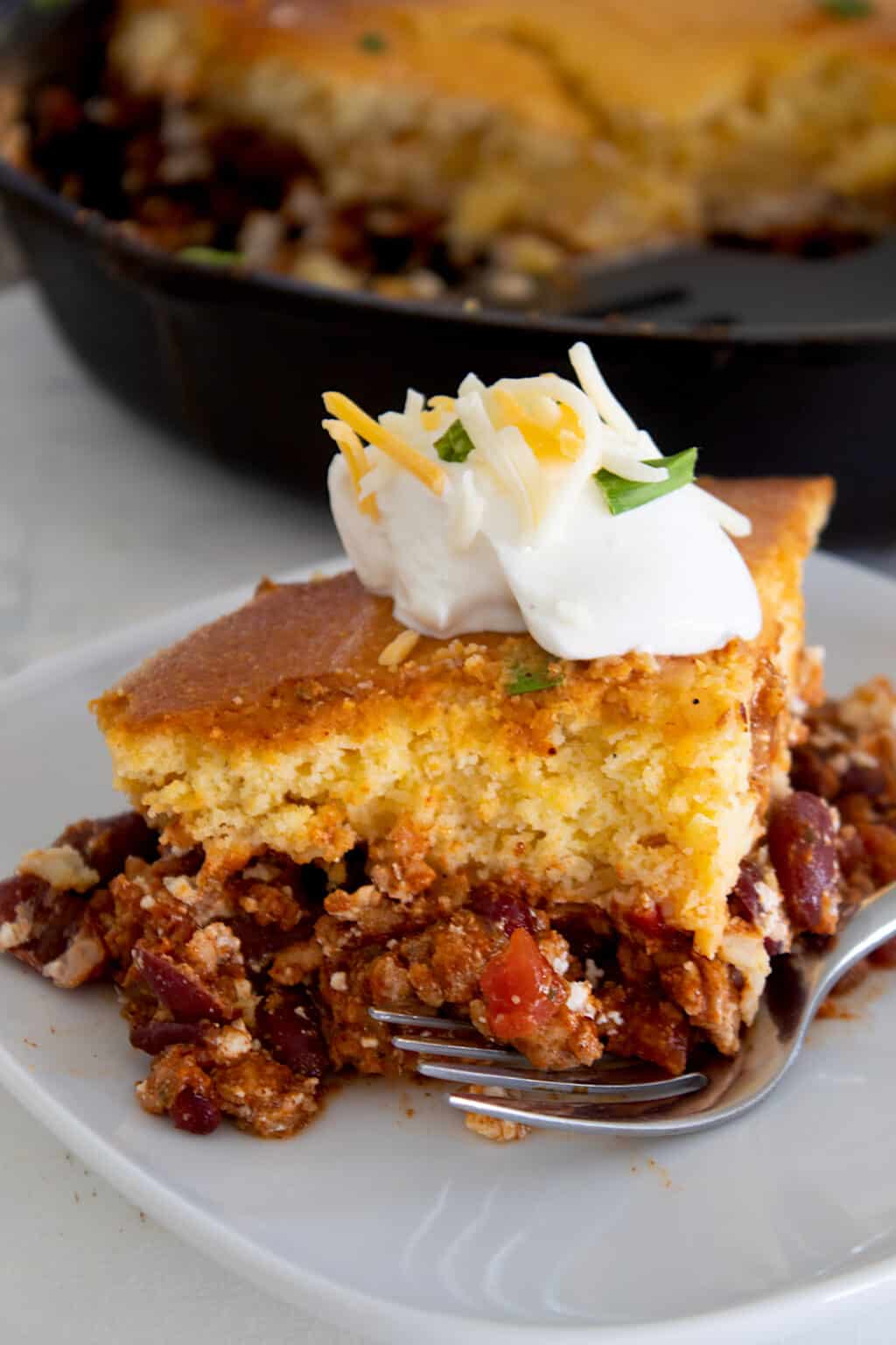 Chunky Chili Casserole · Chili of 3 Meats (Beef, Bison, Venison) & Heirloom Tomato - Topped with Cornbread , Side of Scallion Sour Cream (Serves 2-4)